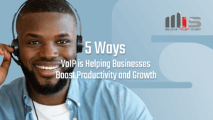Smiling man wearing a headset with overlay text reading “5 Ways VoIP is Helping Businesses Boost Productivity and Growth.” TeamMIS logo is in the upper right corner.
